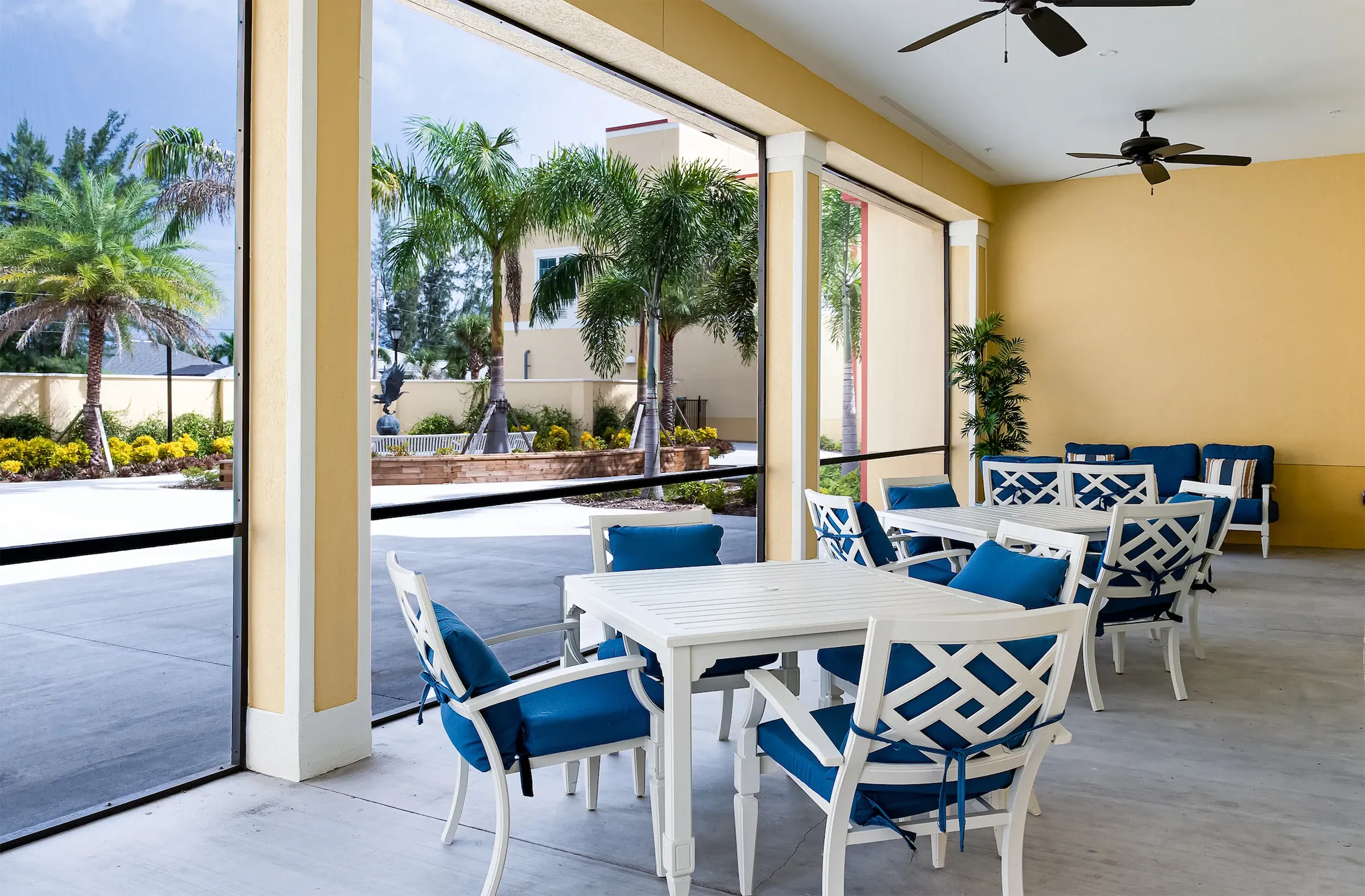 A covered patio with dining seating at The Gallery at Cape Coral.