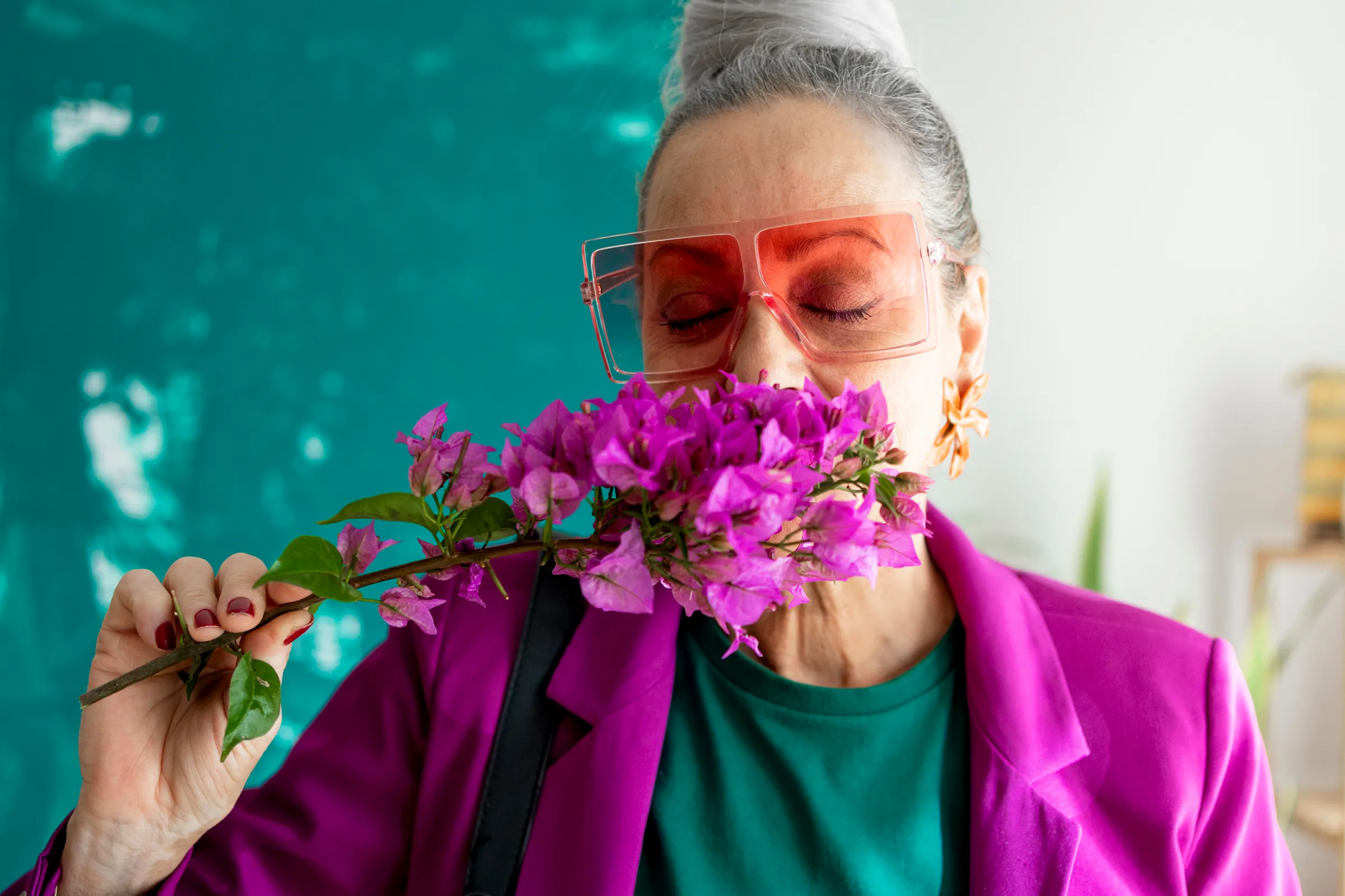 woman smelling purple flowers 