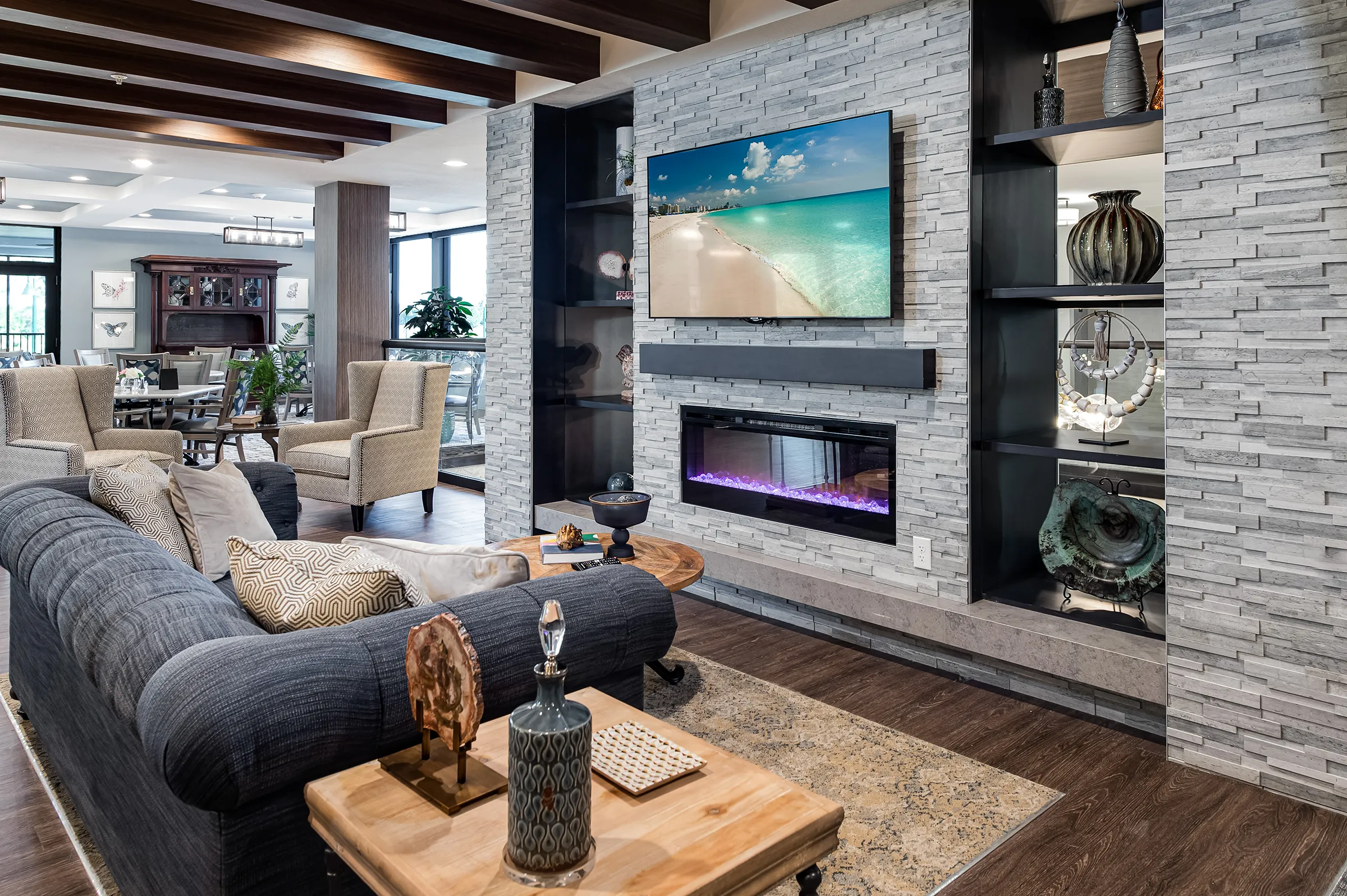 sitting area with television and fireplace inside senior living community