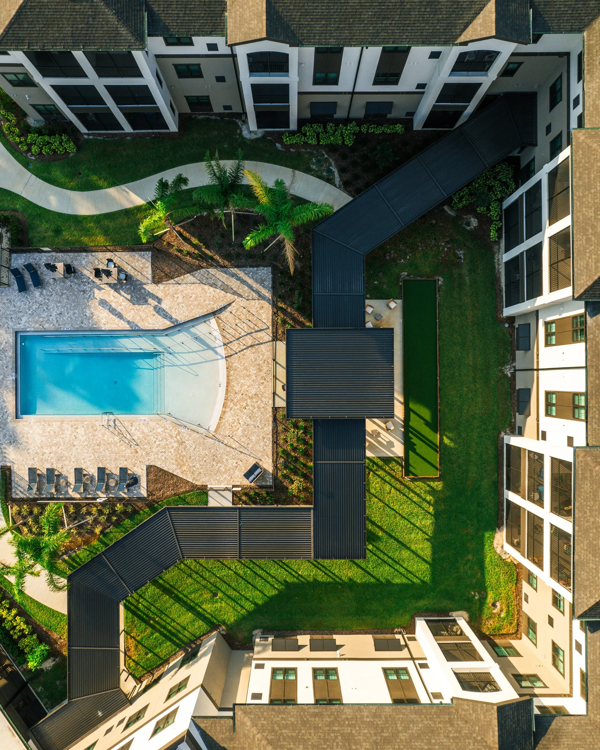 birds eye view of pool and exterior of senior living facility